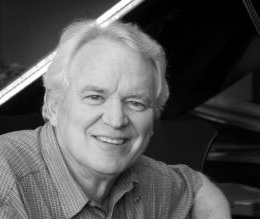 Barney McClure sitting at his piano.