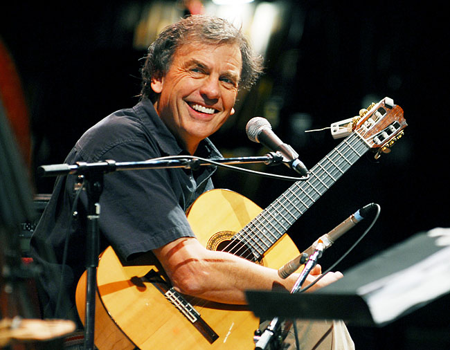Paul Lucas with his guitar on stage.