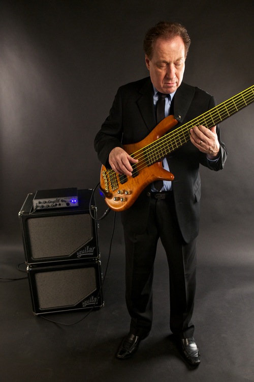Oscar Stagnaro studio shot of him playing his electric bass.